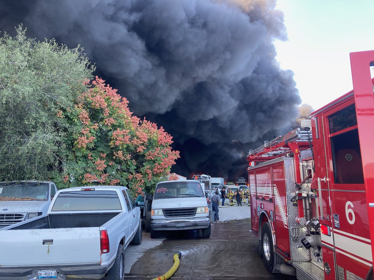 SDFD's tweet photo. SDFD crews working a fire at a wrecking yard on Cactus Rd south of 905 in South Bay. Many crews on scene along with air support. No evacuations at this time. No injuries. #cactusfire https://t.co/GkbZeQI0JA