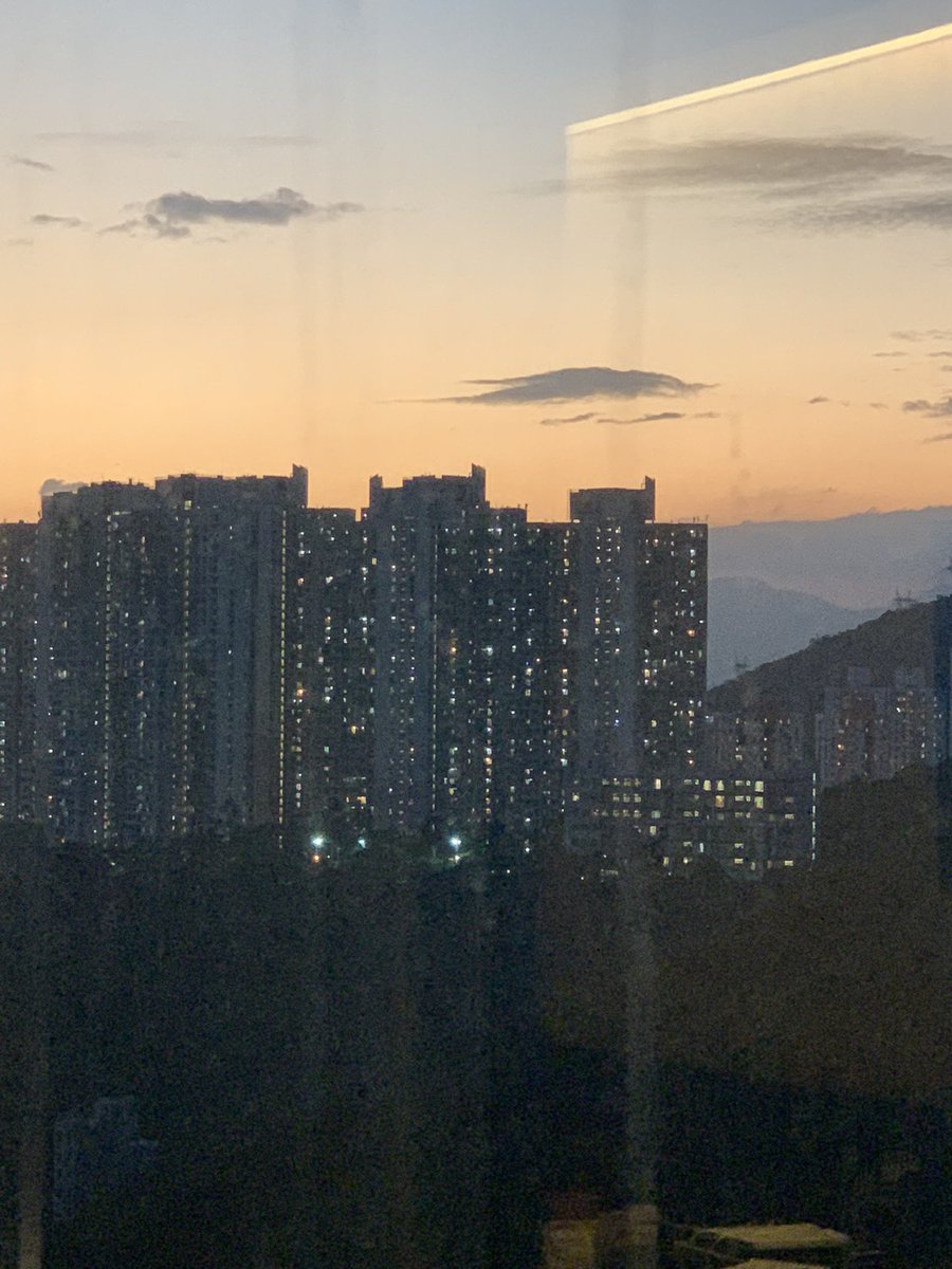 LindyLouMac's tweet photo. Despite the dirty window after all the rain, the afterglow still made a pretty scene, especially during my current limitations! #hongkong #hongkongquarantine #sunsetafterglow #october2021 #postcovidtravel https://t.co/nXbCZHQAhd
