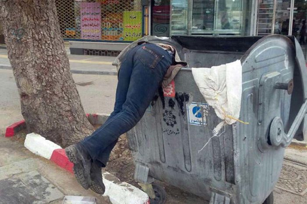 HelenaAva12's tweet photo. A man searching for leftovers inside a trash can, a very common scene in Iran today, due to government’s corruption and spending the country’s income to fund terrorism, development of Ballistic Missile programs, and domestic repression.
#EndPoverty
#40YearsOfFailure https://t.co/llEF3F7NIB