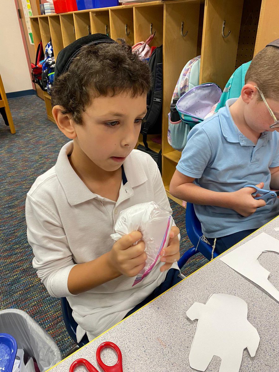 TorahDaySchool's tweet photo. First graders learned about the story elements of setting and characters by engaging in a fun art project based on the book “Beekle”. They colored a background, drew and cut out an outline of the main character, then mixed shaving cream and glue to add on top https://t.co/7YuPj1x6fN