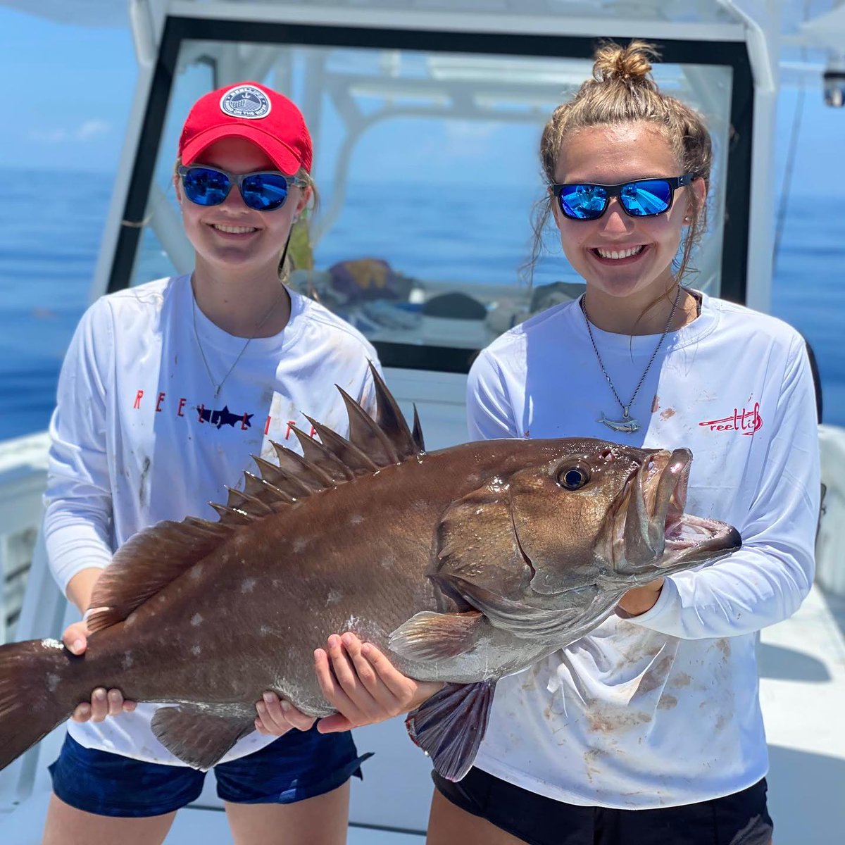 ShurSea's tweet photo. saltysisters.outdoors with a very nice snowy grouper. 👏👏👏 kailey.stockinger wearing the J hook and ash.stockinger wearing the large Mahi 👏👏. Don’t forget to come by the booth this week at Reggae Rise Up in St. Petersburg, FL! Also, I launched a major update to the website. https://t.co/zDItX6curL