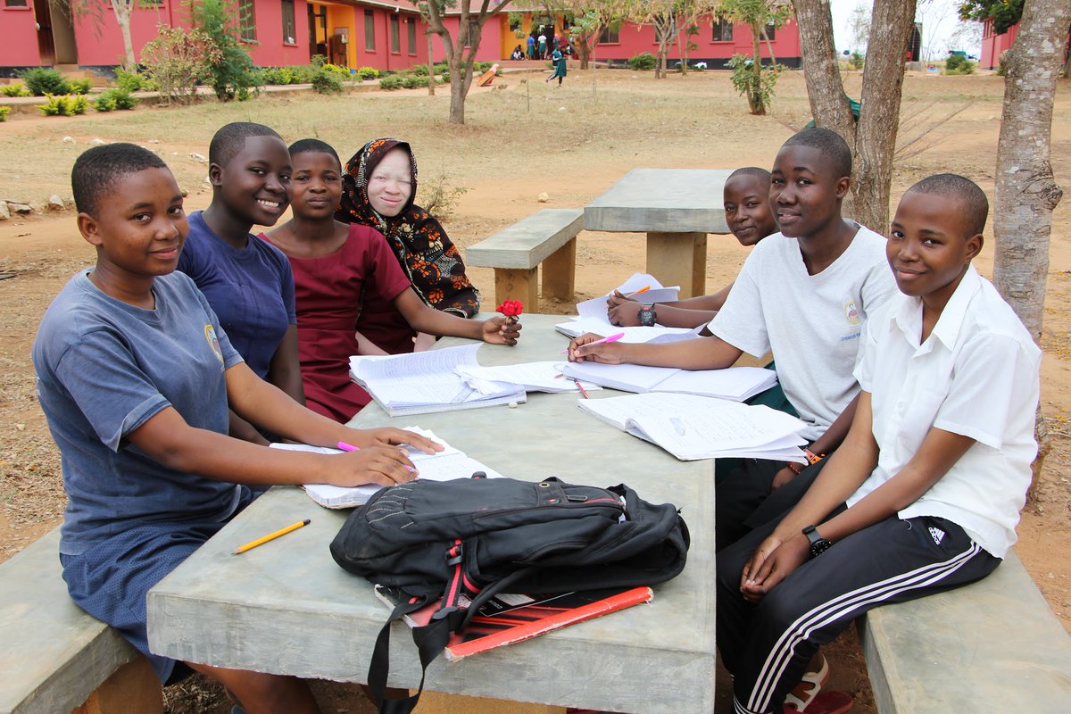 NurturingMinds's tweet photo. Happy faces as the girls reunite with their school mates after a short midterm break. SEGA also welcomed new Preform 1 class who started the English fluency program in preparation for official beginning of Form 1 curriculum in January. #SEGAGirlsSchool #GirlsEducation #Tanzania https://t.co/WxghAvWecy