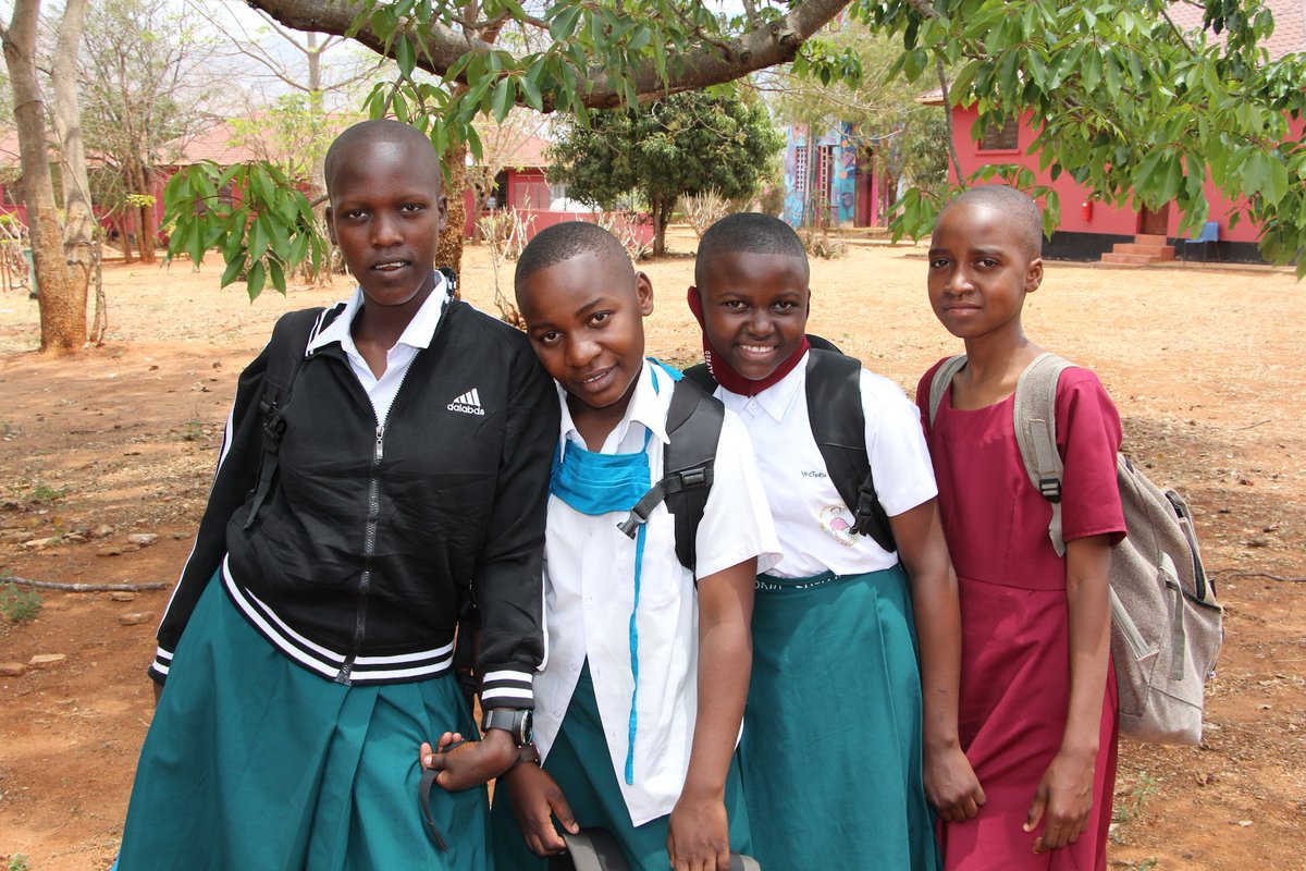 NurturingMinds's tweet photo. Happy faces as the girls reunite with their school mates after a short midterm break. SEGA also welcomed new Preform 1 class who started the English fluency program in preparation for official beginning of Form 1 curriculum in January. #SEGAGirlsSchool #GirlsEducation #Tanzania https://t.co/WxghAvWecy