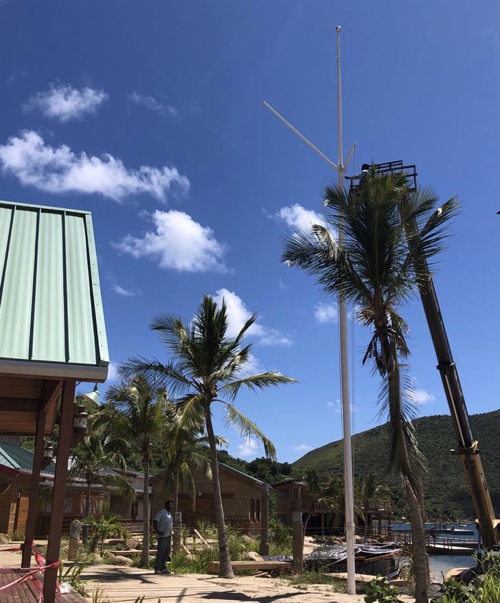 BITTERENDYC's tweet photo. You've seen our new waterfront flagpole from the West looking East (post back on May 12). Rising above the palm tree line. And this past week, we added a gaff to the pole &amp; yard arm. We can't wait to "dress ship" #waterfront #flagpole #BringBackBitterEnd #bitterend #BEYC https://t.co/0CWVeaM2wF
