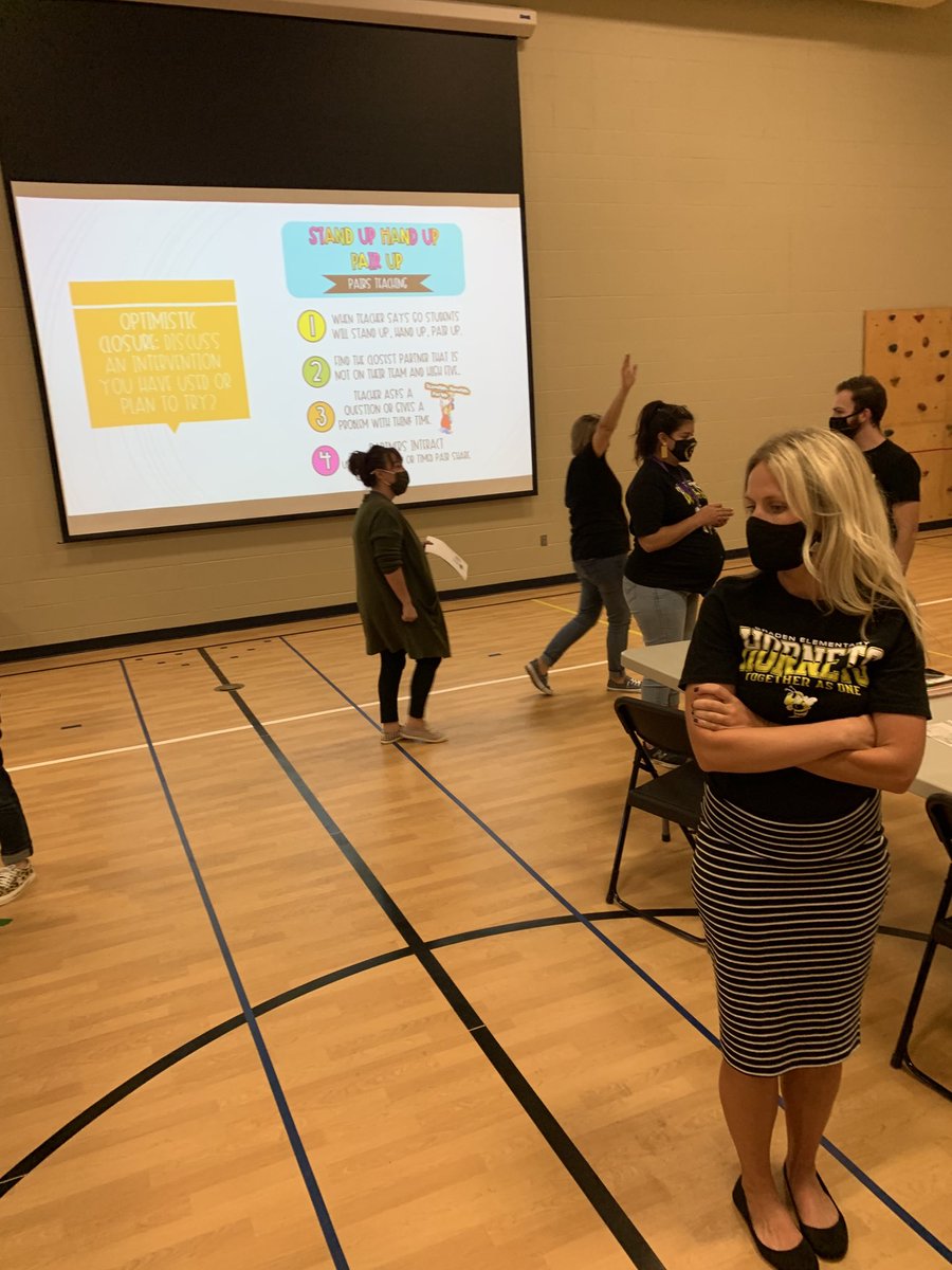 Teachers highly engaged in stand up, hand up, pair up to discuss new learning from our PBIS training #GradenHornets