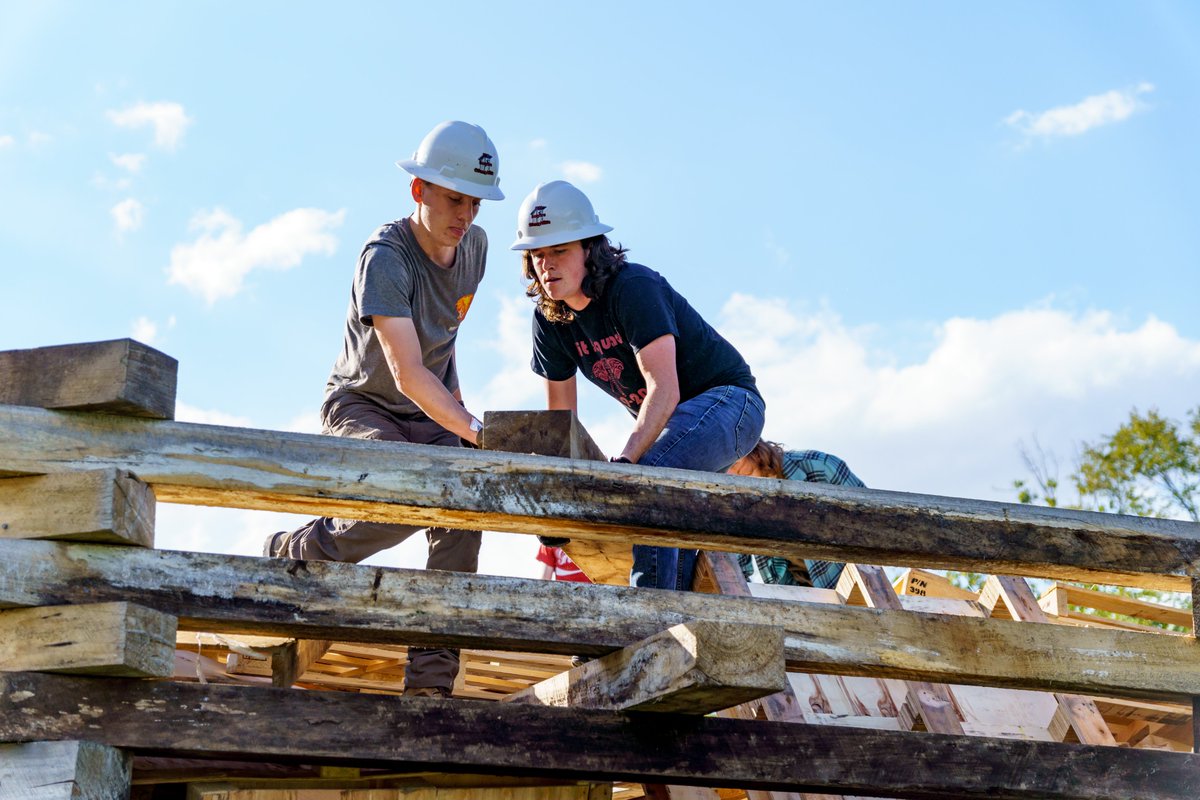 RoseHulman's tweet photo. The ties that bind . . . First-year students are continuing the tradition of building the Homecoming bonfire. It will be set ablaze after Friday night's pep rally. It is great to see students working together to reaffirm our unique campus community. #rosehulman https://t.co/LHXfgxtiPZ