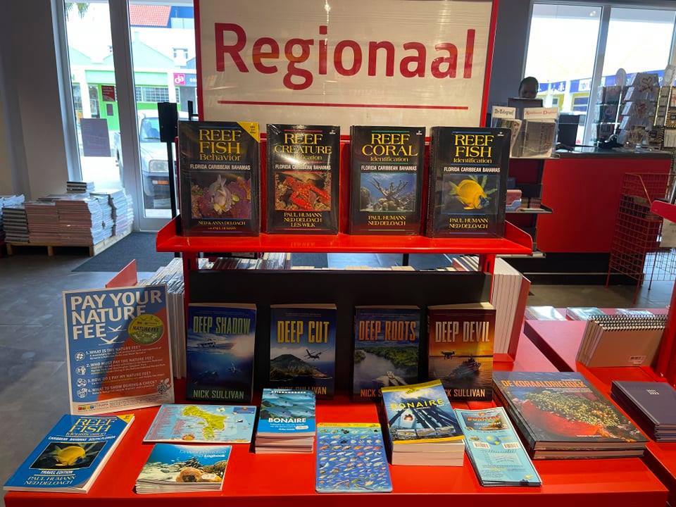 tropicalauthors's tweet photo. This is just... cool. My books at the Bruna Bookstore in #Bonaire! (and right below some of my favorite books)  My thanks to Paul Berezinski of #BonScuba for making this happen. https://t.co/nKWh9HX5VQ