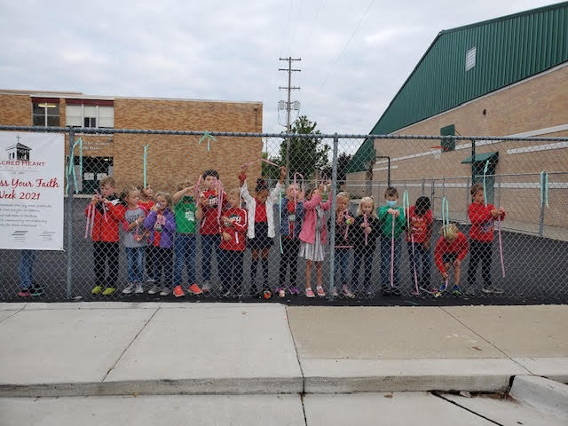 During Express Your Faith Week 2021, students &amp; staff expressed their joy, hope, gratitude, &amp; prayers on ribbons, then tied them to the fence. 
In addition to the prayer ribbons, students also participated in Wear Your Faith to School Day, a Drop Everything &amp; PRAY Day, adoration.