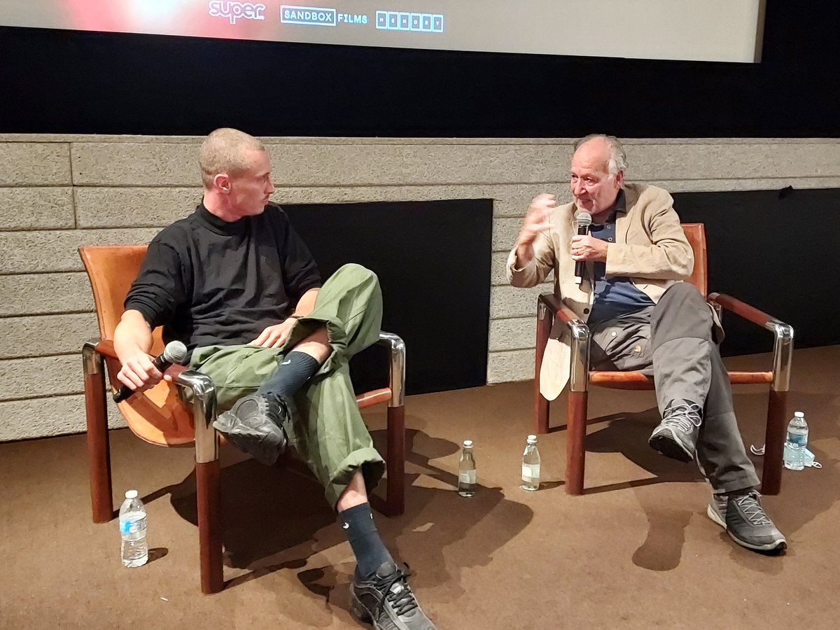 bscritic's tweet photo. I took surveillance photos of #WernerHerzog at a screening of surveillance photography exposé #AllLightEverywhere and it was the most meta thing I've done since the pandemic began. That's the #documentary's astute director #TheoAnthony on the left. https://t.co/Wl2e9XIdc6