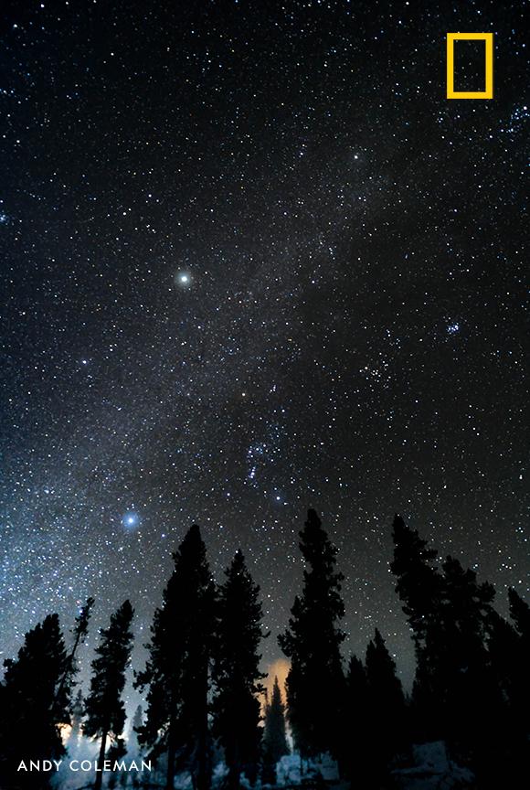 Stars glimmer in this night sky scene captured by photographer Andy Coleman in Yellowstone National Park.