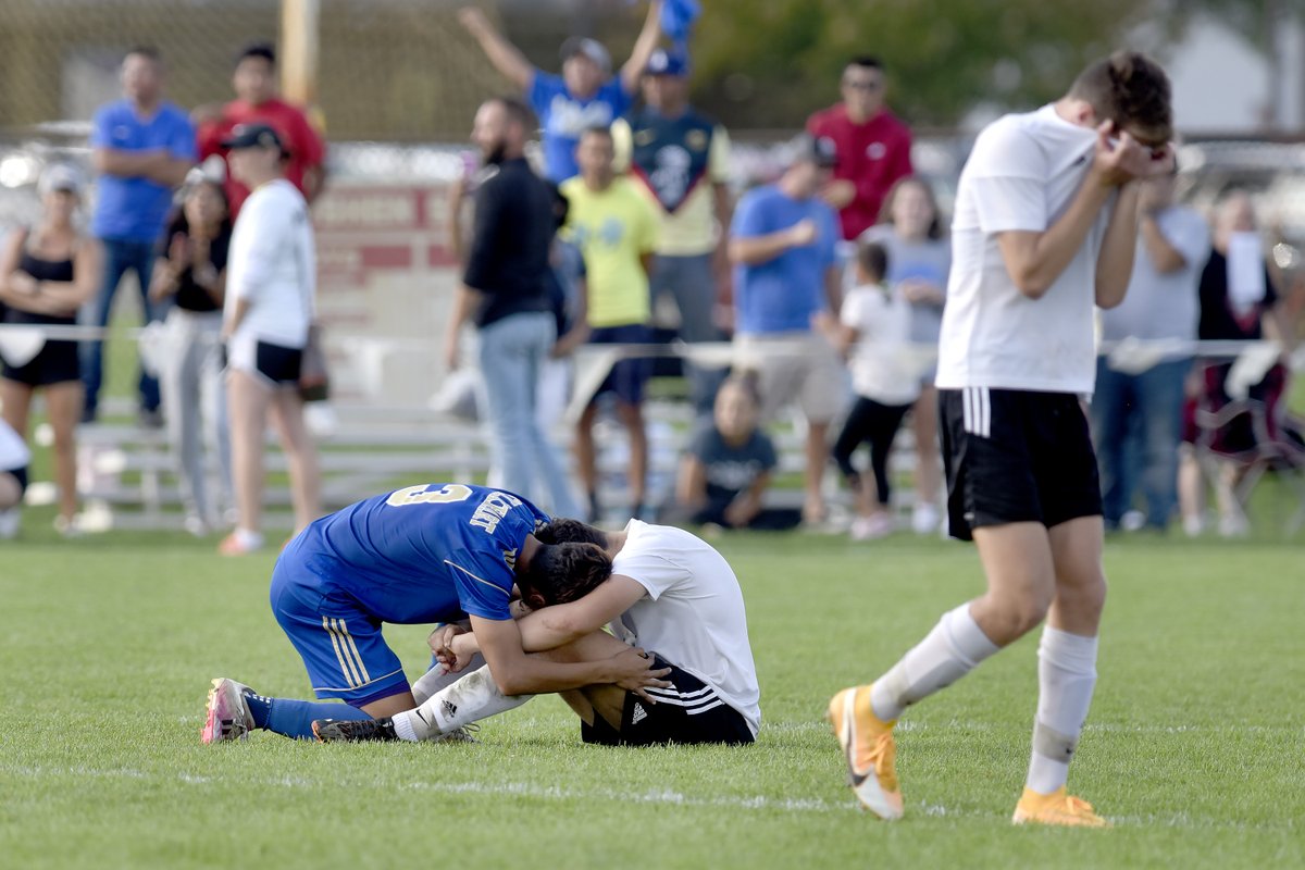 KenFoxTruth's tweet photo. Maybe my favorite picture of the year from our J. Tyler Klassan.. as  @ElkhartHSSports German Mendivil consoles @The_Pennant Tiago DeJesus after the Lions defeated Penn to win the Goshen Sectional. Dusty in here right now. https://t.co/PXMJoyQb0F