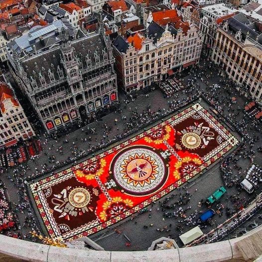 A carpet created from 500,000 dahlia and begonia flowers at Grand Place in Brussels, Belgium. 100 volunteers created this astonishing Floral Carpet that stretches out 19,000 sq. ft. Every two years it's a different cultural theme. This one honors Mexico &amp; Aztec Culture.