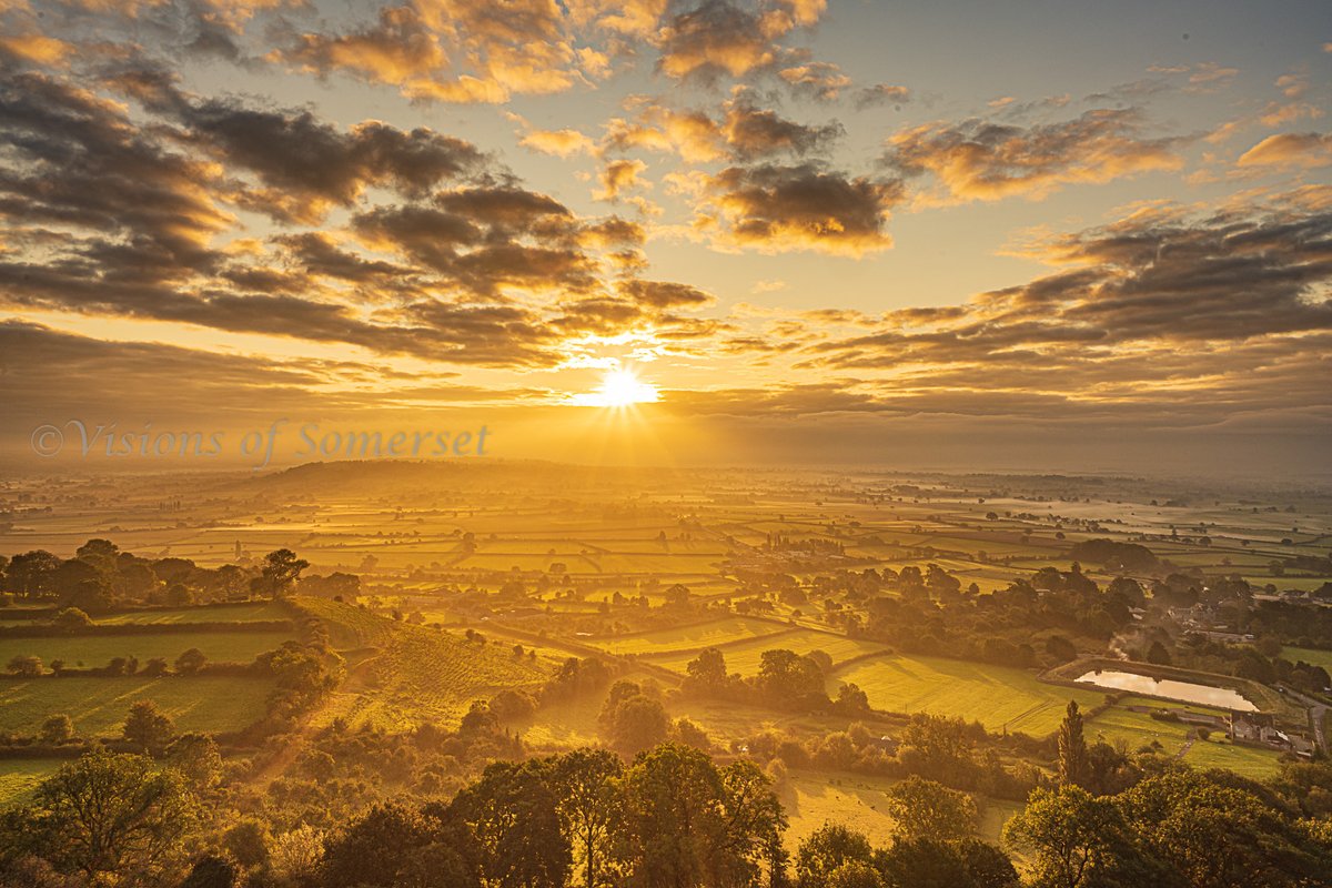 I waited on Glastonbury Tor for about an hour after sunrise today and the sun came out and lit the land with a golden glow.