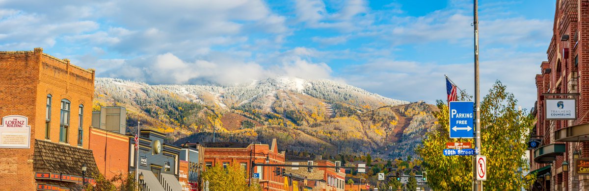 StmbtElliot's tweet photo. A little panoramic of downtown Steamboat Springs this afternoon with a little sunshine, fresh snow and a few fall colors still sticking around - October 10th, 2021 #steamboatsnaps #colorado #fallintherockies #steamboatresort https://t.co/NR9i767R94