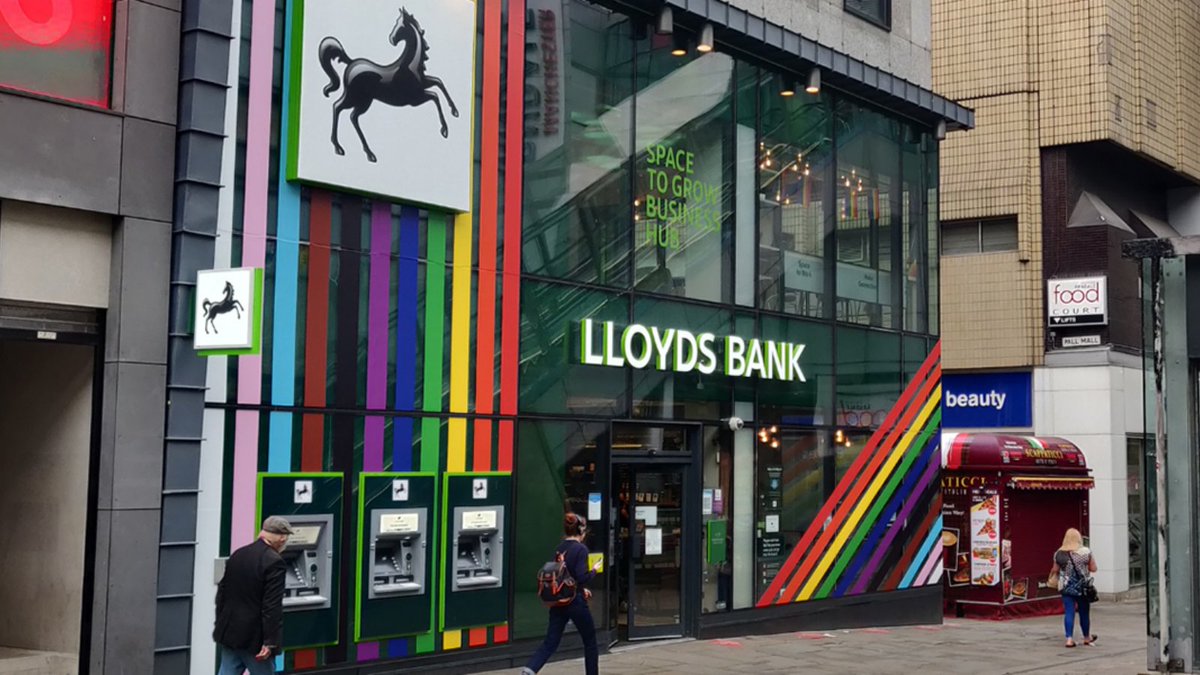 LloydsBank's tweet photo. This #WorldComingOutDay our colleagues are making sure everyone feels welcome in our branches, helping to create an inclusive bank for all our customers, communities and colleagues. #ByYourSide https://t.co/0ulFuH3mtK
