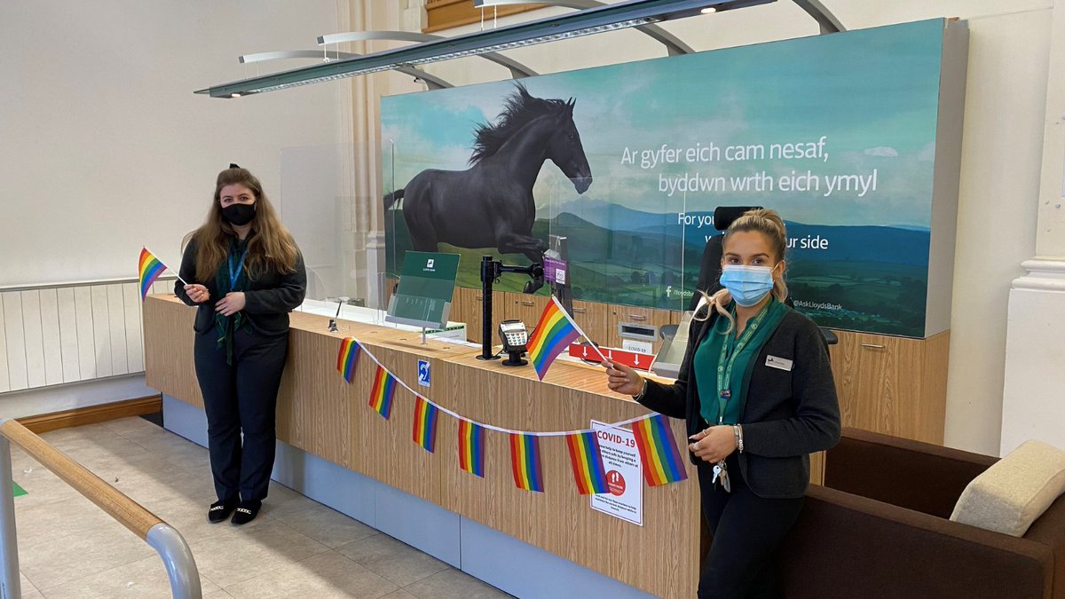 LloydsBank's tweet photo. This #WorldComingOutDay our colleagues are making sure everyone feels welcome in our branches, helping to create an inclusive bank for all our customers, communities and colleagues. #ByYourSide https://t.co/0ulFuH3mtK