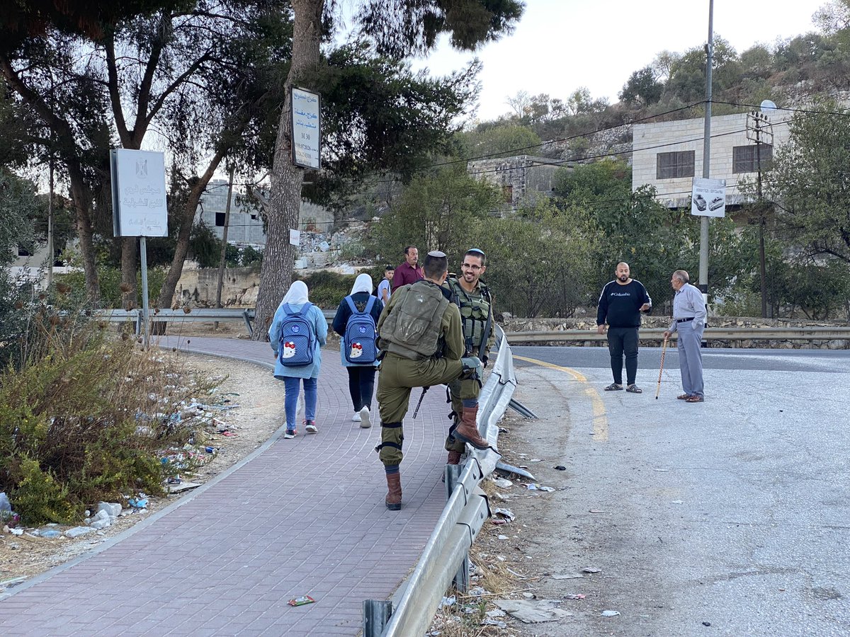 AlaaDaraghme's tweet photo. Students of Libban Al Sharqyeh school heading to their school surrounding by their teachers due to the tension around the school as Israeli soldiers have been preventing students from using the road leading to their school.
The army says students throw stones on settlers vehicles https://t.co/V2SNsy830o