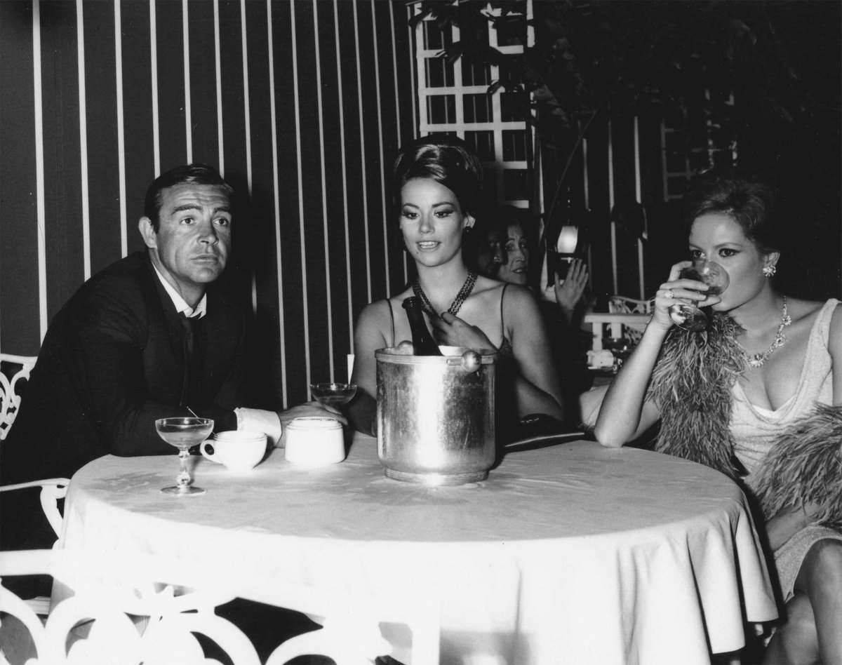 Behind the scenes with Sean Connery, Claudine Auger and Luciana Paluzzi on location in Bay Street, Nassau, The Bahamas, during filming for Thunderball (1965) #Bond #JamesBond #BehindTheScenes Visit thunderballs.org