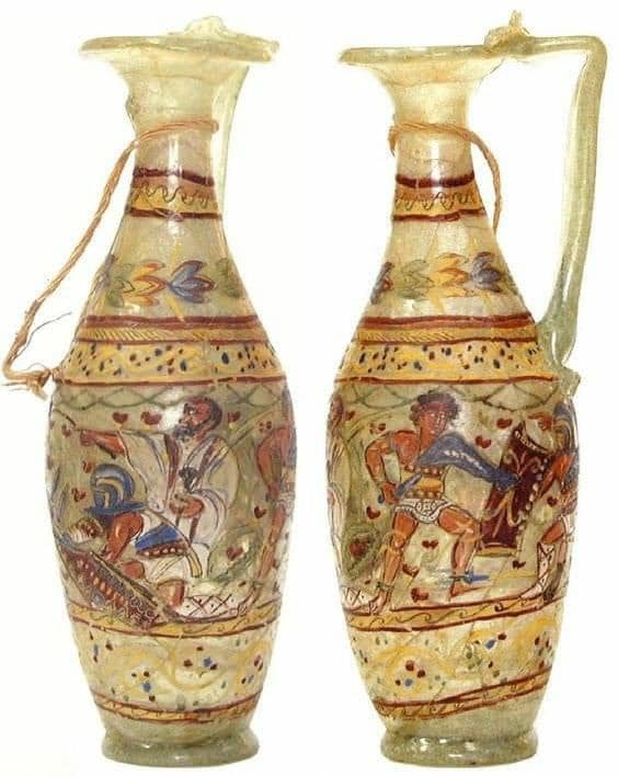 Two splendid Roman glass jugs painted in enamel from the 1st century AD. Found in Ismant el Karab, ancient Kellis in Egypt. Fights between gladiators are represented.