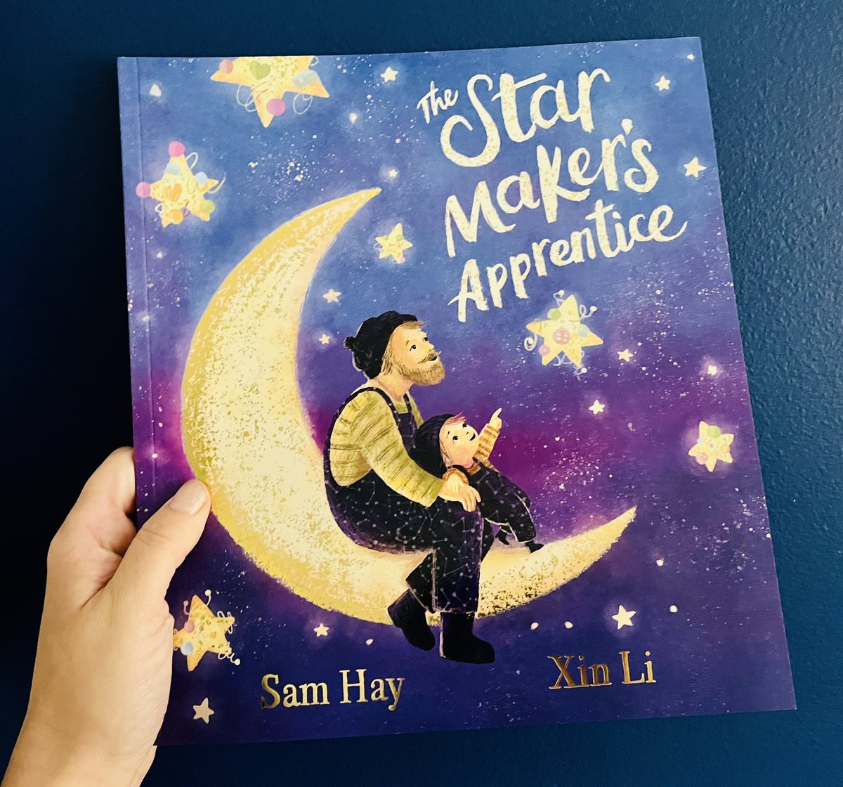 BookSuperhero2's tweet photo. Look at this beautiful copy of #TheStarMakersApprentice by @samhayauthor, ills. by #XinLi✨ 

Finn’s father makes &amp; mends stars. Finn longs to help but his ideas are a little different. When dad falls ill, Finn steps in to help with a twinkle of stardust &amp; a heap of creativity. https://t.co/bWau7d6DE9