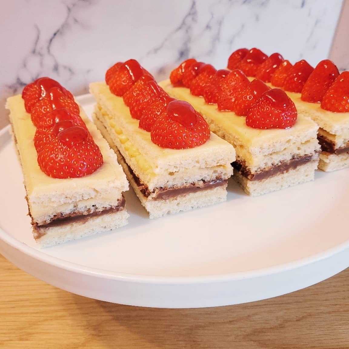 CuriousGFBaker's tweet image. For The Great British Bake off this week I have baked mini Opera Cakes as the showstopper is making a joconde sponge! 
This has a crème pâtissière and chocolate ganache filling with strawberries and a compote glaze! All gluten free! 
#gbbo #showstopper