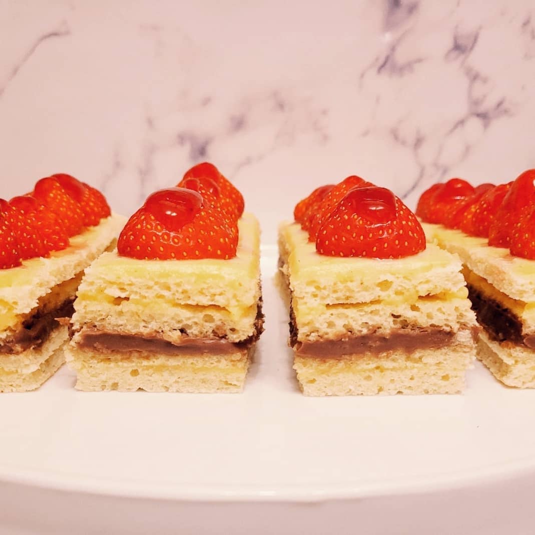 CuriousGFBaker's tweet image. For The Great British Bake off this week I have baked mini Opera Cakes as the showstopper is making a joconde sponge! 
This has a crème pâtissière and chocolate ganache filling with strawberries and a compote glaze! All gluten free! 
#gbbo #showstopper