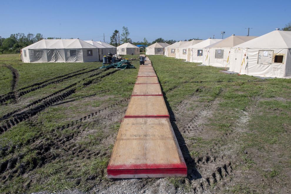 NOLAnews's tweet photo. Weeks after Hurricane Ida, many Louisiana residents are still living in makeshift shelters. Out of 13,818 survivors in Terrebonne and Lafourche parishes eligible for a hotel stay through FEMA aid, only 11% were checked into a room. See pictures of current living conditions: https://t.co/wDmOJJgHSj