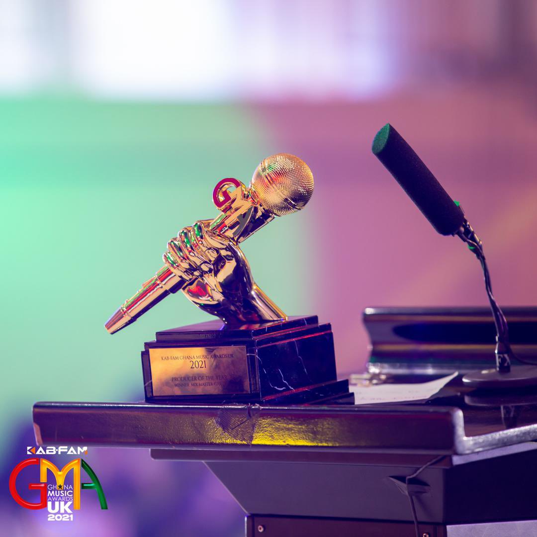 Our current TROPHY depicts a hand holding a mic, rooted in a firm base.
••••
THE HAND signifies togetherness.
THE MIC, our  collective voice. 
THE BLACK AND GOLD BASE signifies our identity, who we are and where we come from.
•••••
#kgmauk21 #inspiredbymusic #gmaukxtra