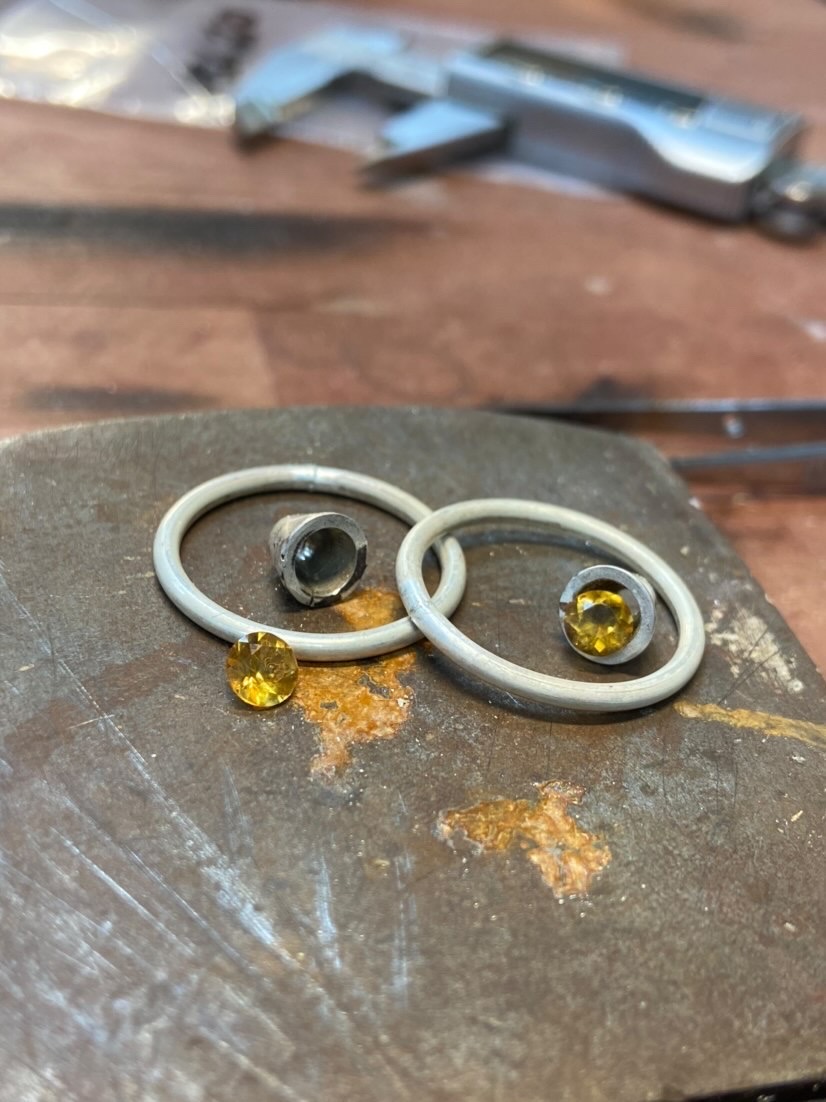 BAJ_UK's tweet photo. BAJ student Ed @e.j.haire is busy back in the workshop as term begins again. Ed is working on a pair of citrine hoop earrings, an amber claw pendant, and rex collet/ split shank rings.
What jewellery projects are you working on the the moment?
#jewellerymaking #BAJstudents https://t.co/7Je0O6R6oU