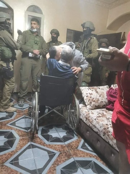 Mvoice13's tweet photo. A #Palestinian young man bids his paralyzed father a farewell before being taken away by #Israeli occupation forces who raided his house in the town of Beit Sahour, southern the  #WestBank, last night. #ApartheidIsrael #IsraeliCrimes   @Mvoice13 https://t.co/JKI5rbOWMS