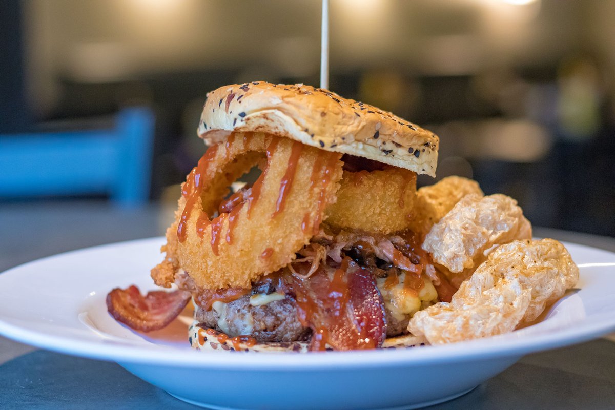Feeling hungry and adventurous? Look no further than our Cowboy Burger.

This monster is made with a half lb Bison patty, smoked gouda, sautéed baby portobellos, onion rings, bacon, pulled pork and BBQ sauce on a brioche bun.

Yippie ki yay!