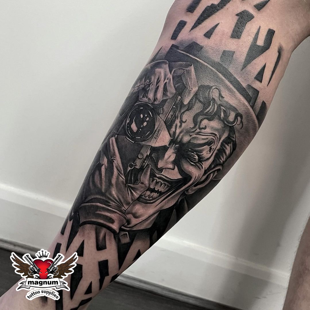 Black and grey The Joker portrait tattoo located on