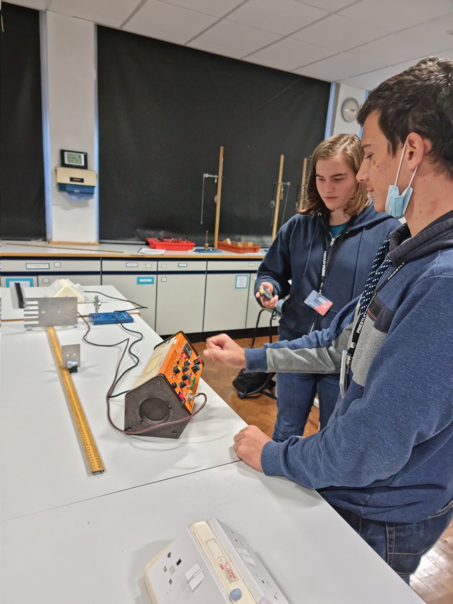 Some A Level Physics students carrying out their Inverse Square Law Experiment for Gamma Radiation after completing through research on an appropriate method and how to process the results.
