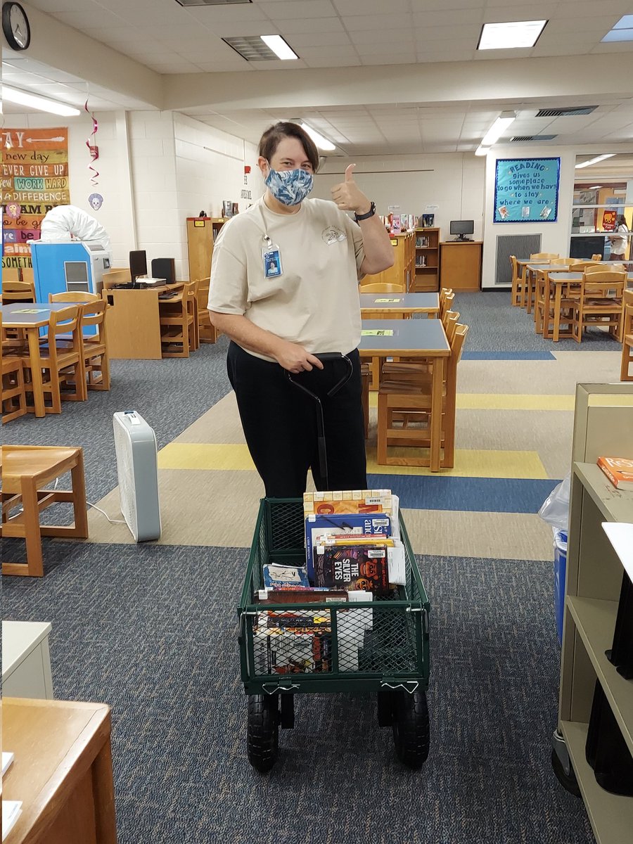 Ms. Bailey delivered books on hold to students in modular classrooms today using our new all-terrain book cart.