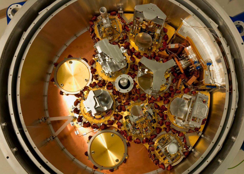 Inner workings of an antenna receiver with cogs, gears, and wiring.