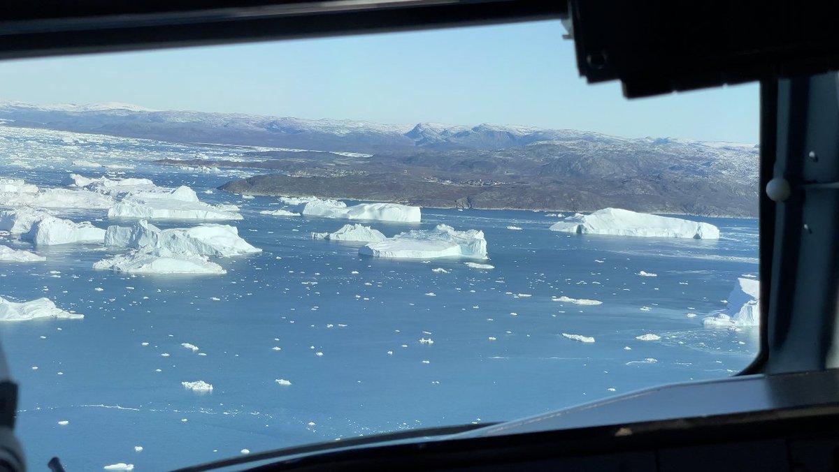 Icebergs in the bay approaching Ilulissat on the flight deck of an Air Greenland Dash 8