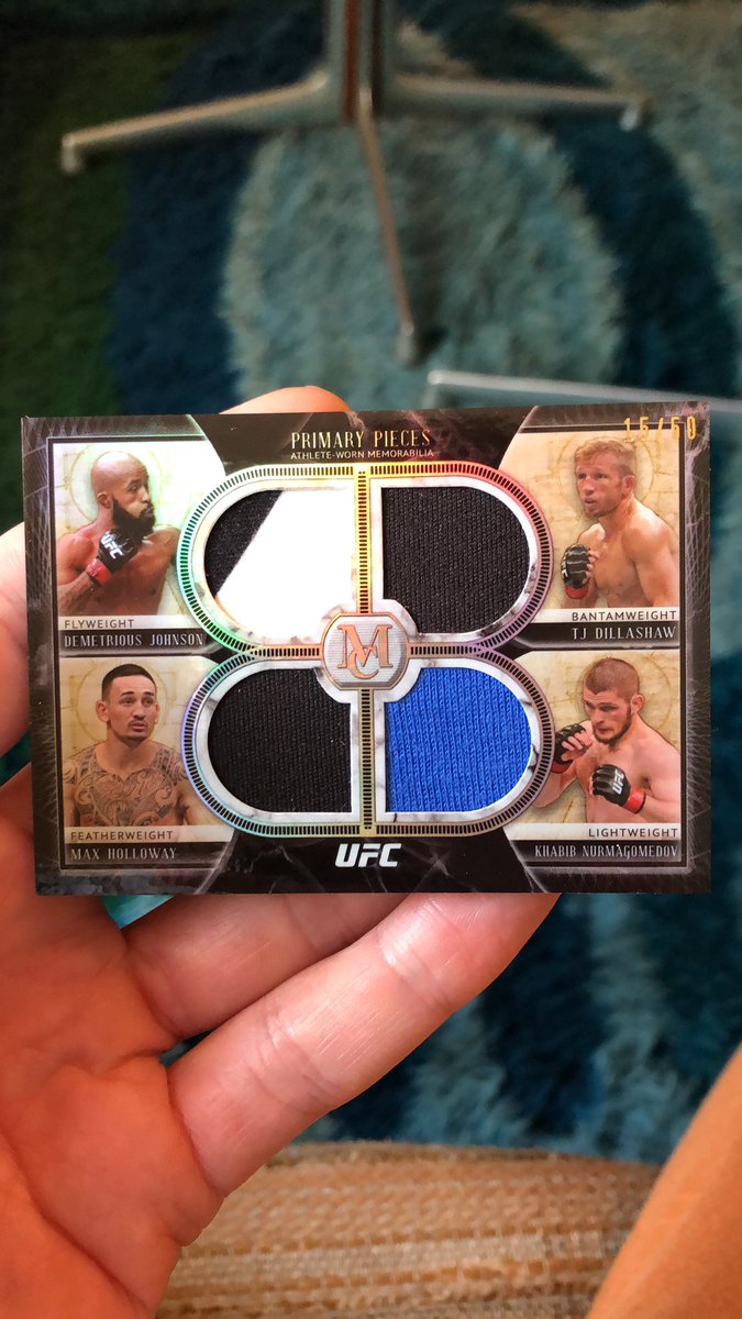 Love this quad relic that has pieces of gear from DJ, TJ, Max, and Khabib inside it. Serial numbered to /50.