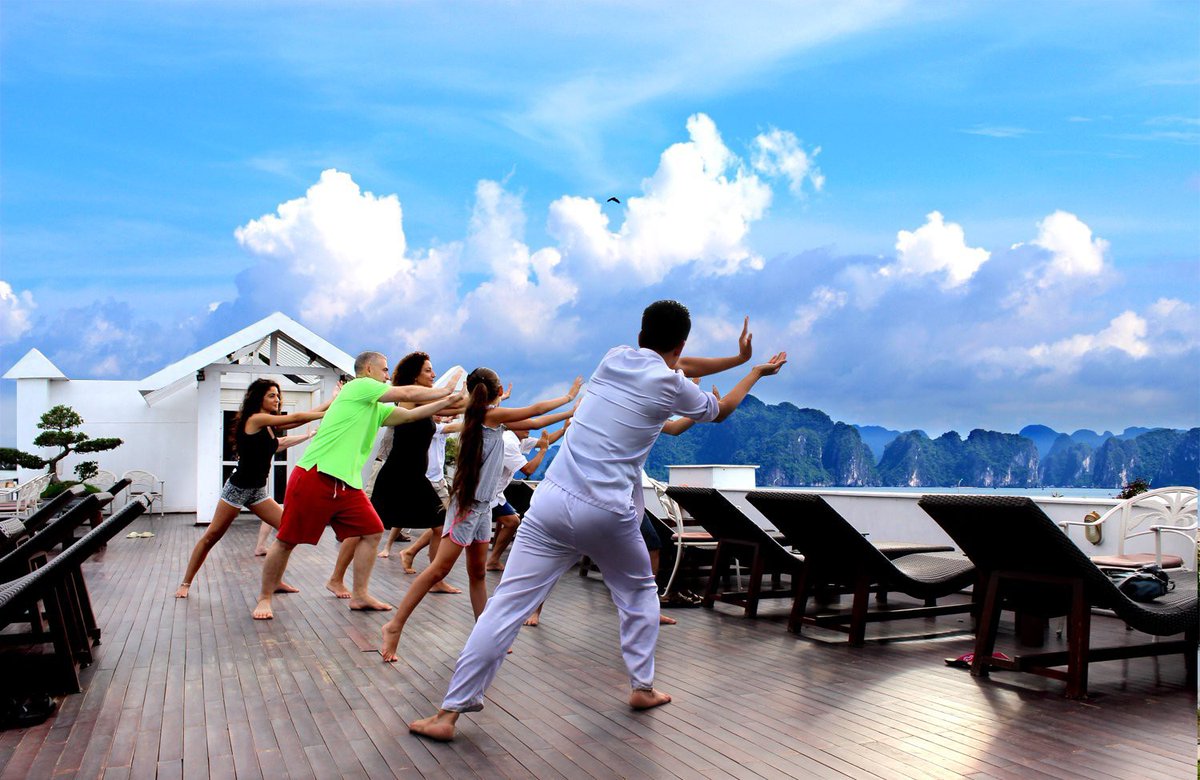 ViettinT's tweet photo. A refreshing sunrise #TaiChi lesson is one of the complementary activities on cruises in the world famous #HaLongBay. The lessons introduced on board have been simplified so that every passenger can learn how to rejuvenate the body and mind. https://t.co/f2jWJTLkma
