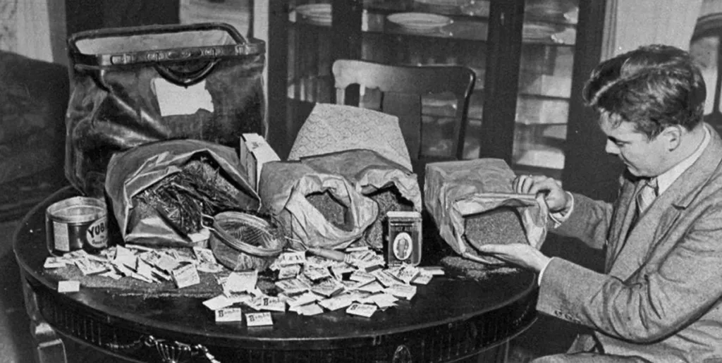cannaworldsite's tweet photo. ‘A detective examines marijuana and paraphernalia found at 17 Concord Street in Dumbo.’ Brooklyn, New York undated (late 30’s/early 40’s) https://t.co/M21DEsQiwt