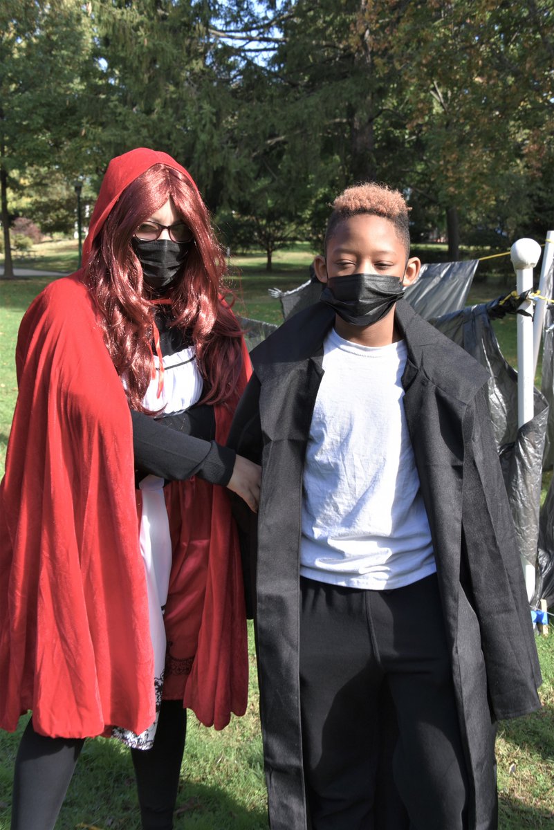 A teacher and a student pose together in a little red riding hood and samurai costume