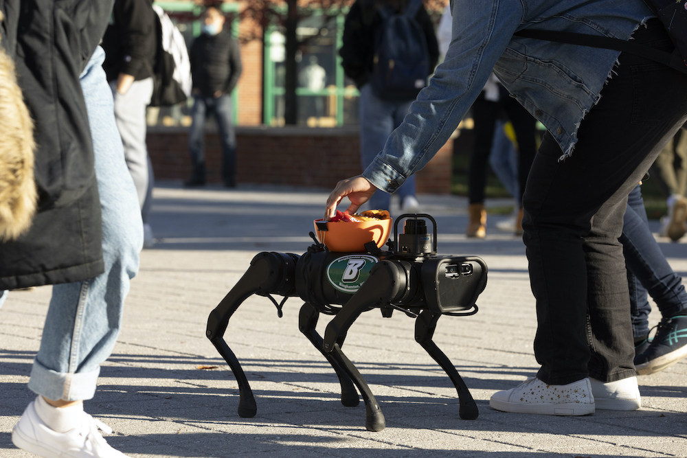 binghamtonu's tweet photo. Assistant Professor Shiqi Zhang from the Dept. of Computer Science and his students took their robot "dog" to the DeFleur Walkway to hand out some Halloween candy. π€πΆπππ« #Bingoween https://t.co/Xmc1g1o9Ac