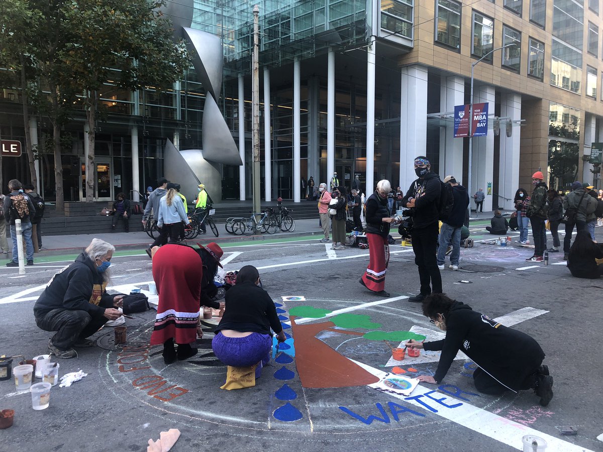 RaquelMDillon's tweet photo. Young #climate activists paint street murals outside @BlackRock’s SF offices. This medallion was designed by @UrbanTilth from #Richmond. They’re calling on investment banks to #DefundClimateChaos. @KQEDnews @KQEDscience #sanfrancisco https://t.co/UF5pzlC1dG