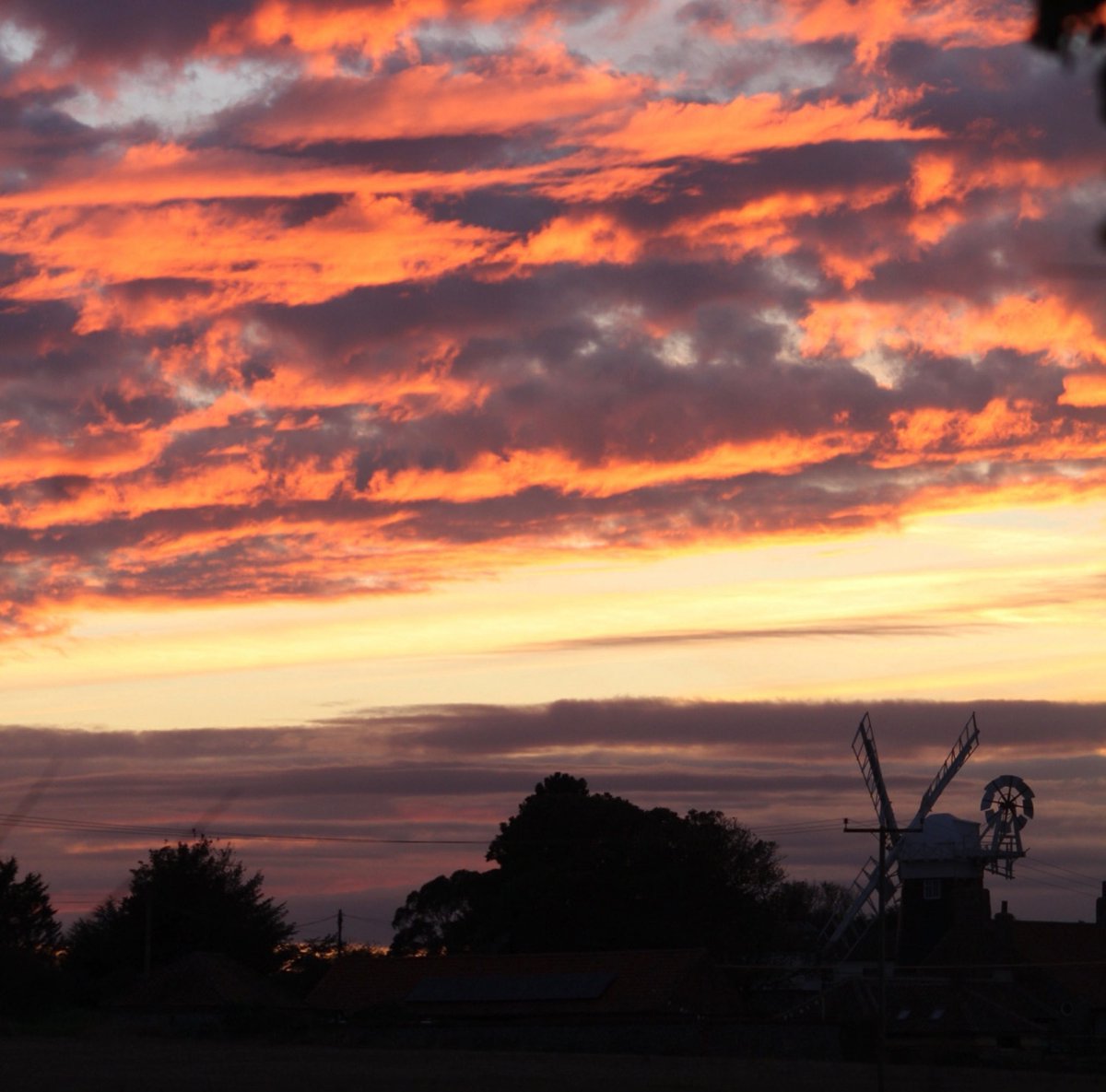 #LoveUKWeather fiery clouds over the windmill in Norfolk
