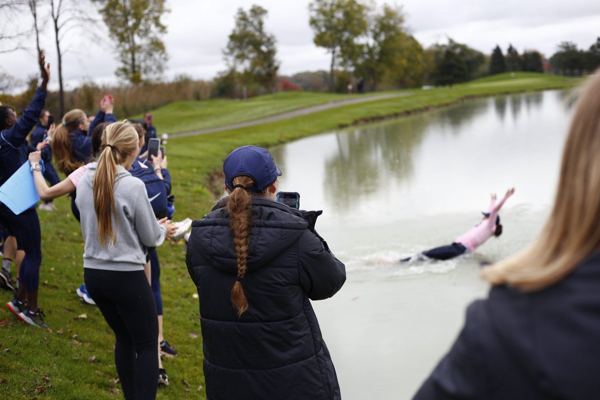 ToledoXCTF's tweet photo. .⁦@andreagrovemcd⁩ takes the plunge after the Toledo women take 1st at MAC XC championship! Rocket men take best ever 2nd! Great day to be a Rocket! #MACChamps https://t.co/yaYGhFKAFw