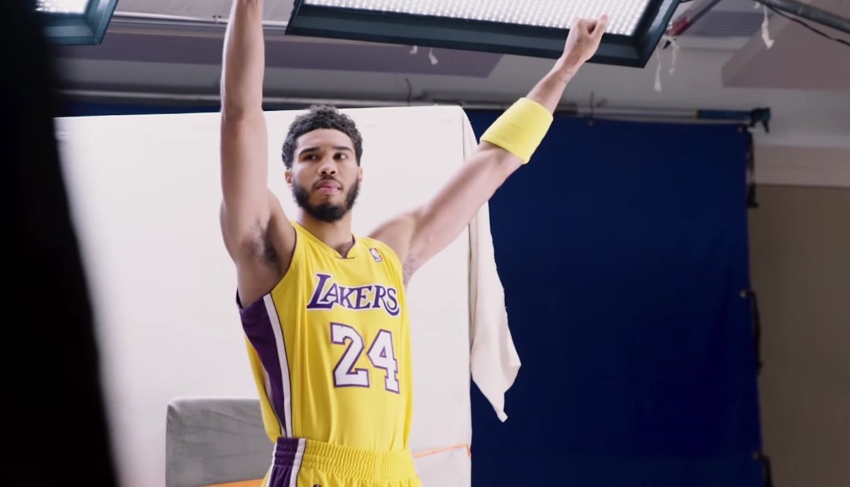 jayson tatum in los angeles lakers jersey, holding the