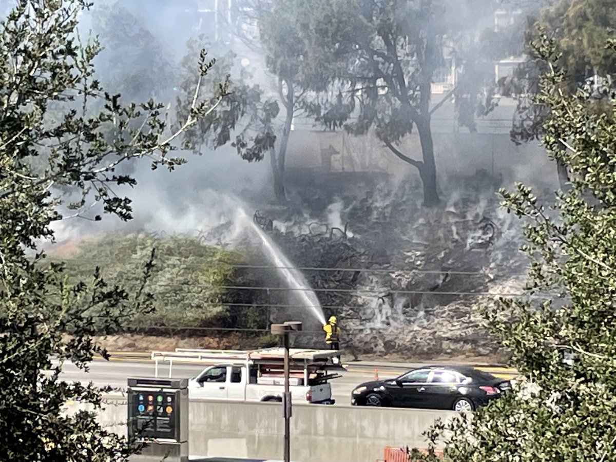 Fire fighters douse brush fire at Lake  Avenue and 210 Freeway in pasadena #SCNG SGVN #pasadenastarnews