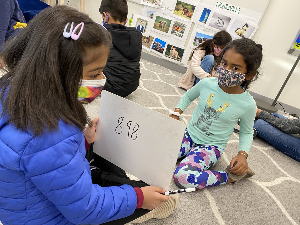 MrsLaHaitGPE's tweet photo. Our second grade classroom at @GoshenPostES was buzzing with math vocabulary while we played a place value version of “Guess Who?” during @LCPS_Math workshop today! #GoGPGators #LCPSMath https://t.co/ppxygXi2xu