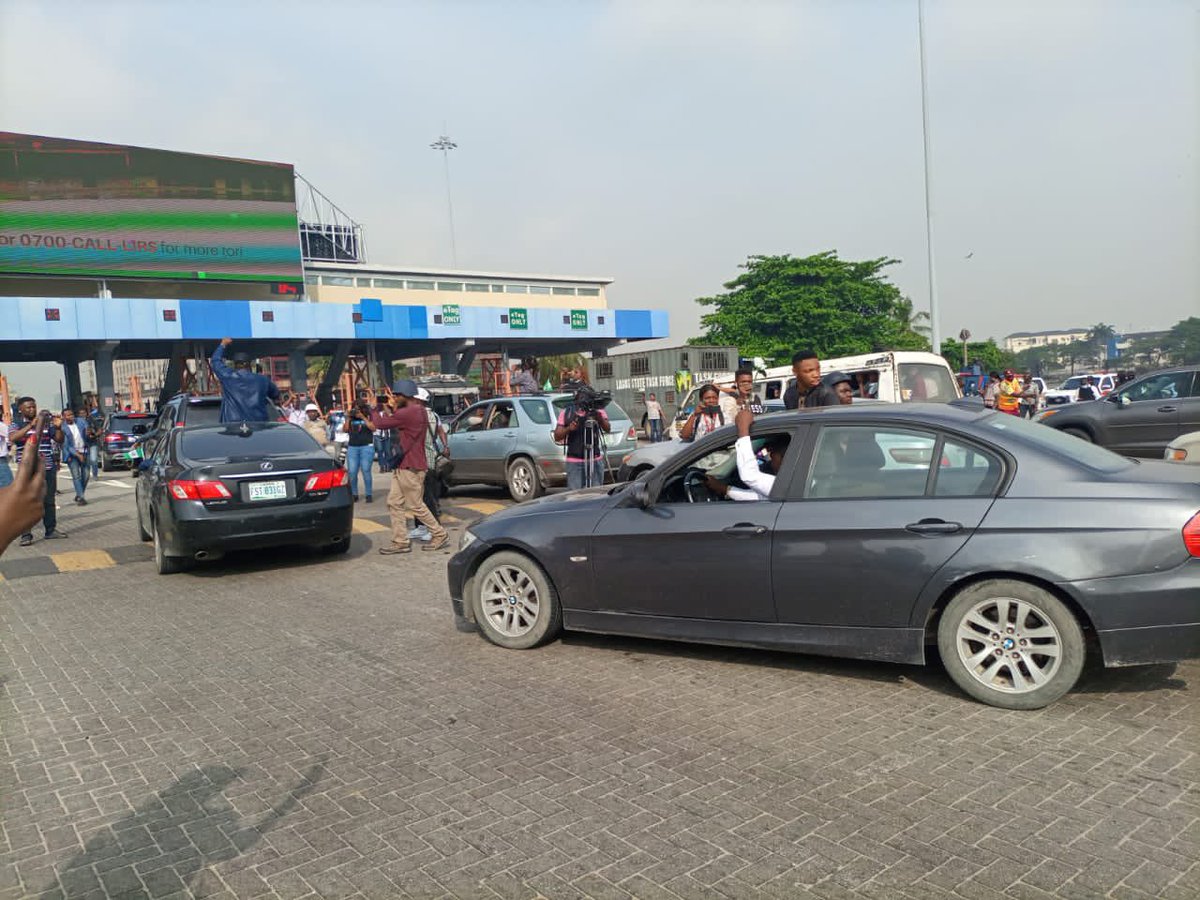 EiENigeria's tweet photo. The momentum is building at Lekki toll gate, venue of the #EndSARSMemorial on the Island despite heavy police presence! Join us! 
#EndSARS https://t.co/YxbrX8LYUz