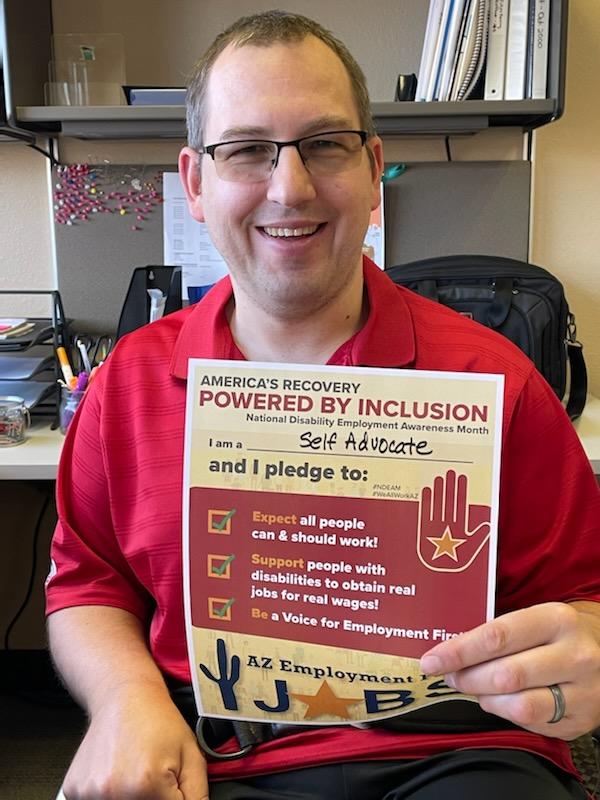 AzDDPC's tweet photo. Jason Snead the Research and Communication Specialist for the Arizona Developmental Disabilities Planning Council proudly signs the Employment First Pledge in honor of National Disability Employment Awareness Month (NDEAM). #NDEAM #NDEAM2021 #weallworkaz https://t.co/p0wpkG7VBF