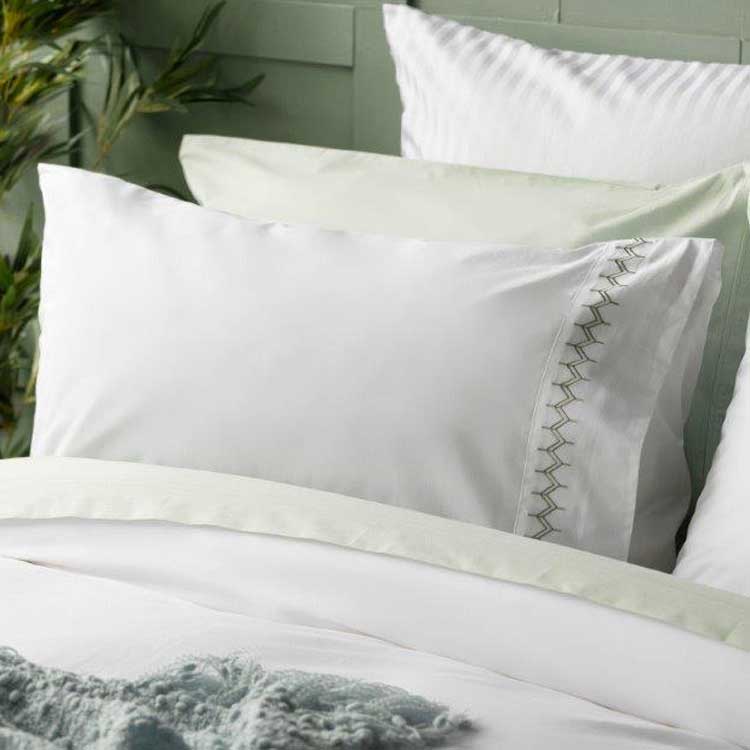 Luna Cotton Duvet Cover Sets are made from pure cotton percale for extra comfort and quality. bedlinendirect.co.uk/luna-cotton-du… Features a double row of zig zag embroidery in thyme green shade on a crisp white background.